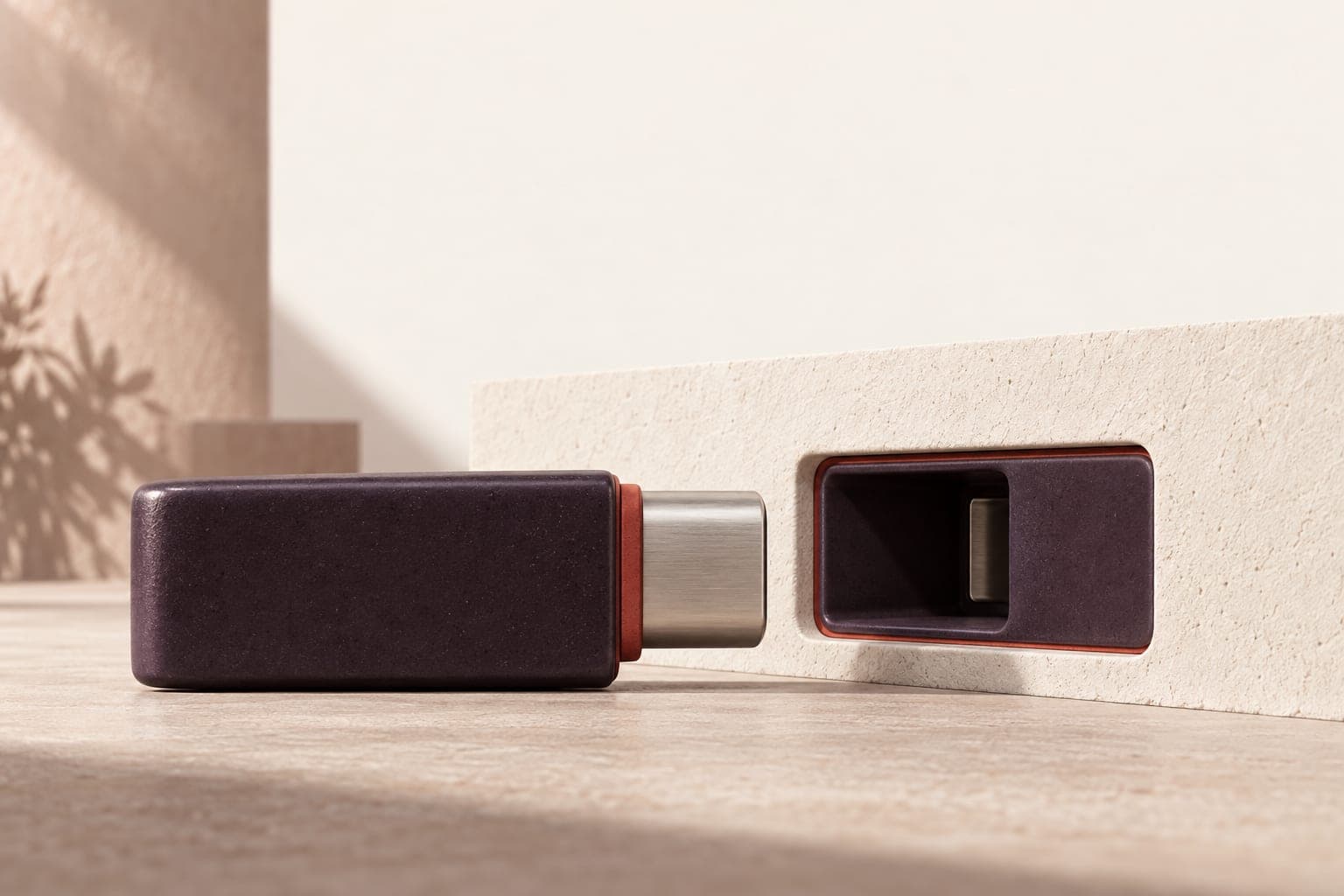 Plum ceramic plug approaching a matching recessed socket.